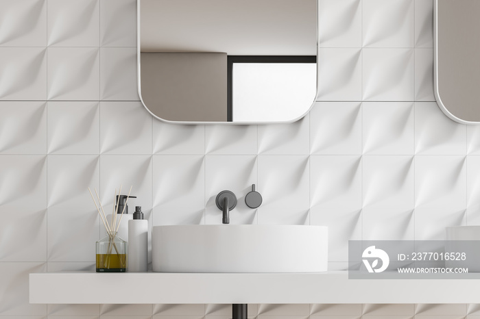 White tiled bathroom interior with sink