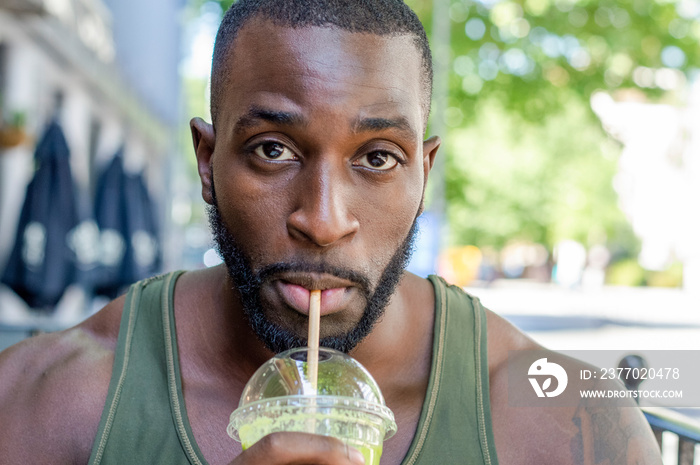 Mid adult man drinking smoothie