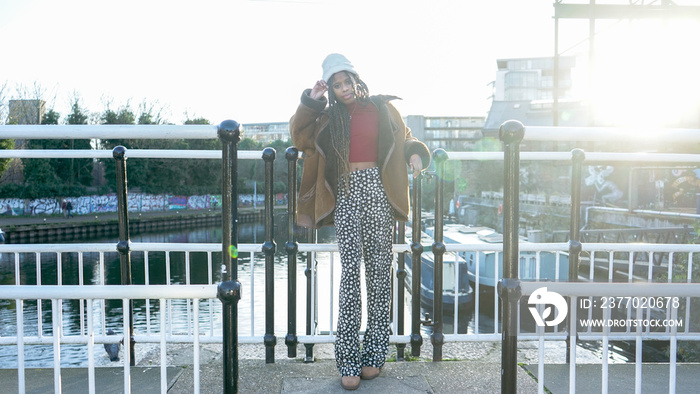 Portrait of stylish young woman on bridge