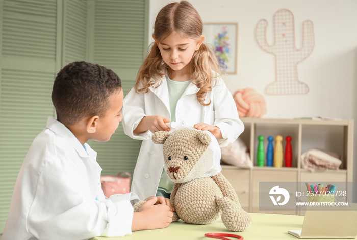 Cute little children dressed as doctors playing at home