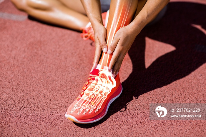 Low section of athlete suffering from pain on track