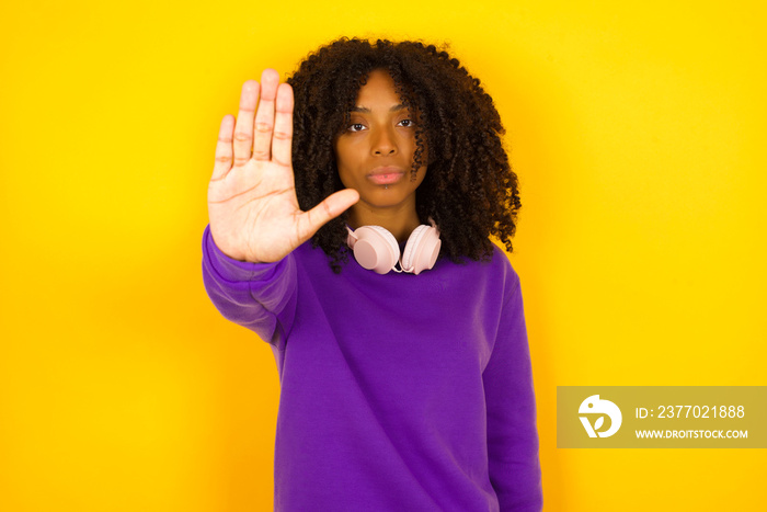 Young beautiful caucasian woman doing stop gesture with palm of the hand. Warning expression with negative and serious gesture on the face isolated over gray background.