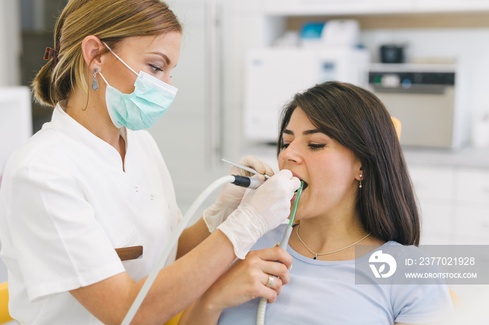 Woman repairing teeth at the dentist office