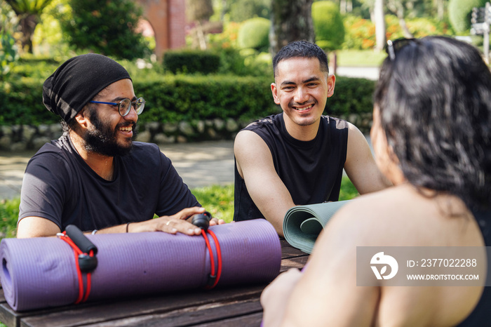 Groups of friends chatting together before doing yoga