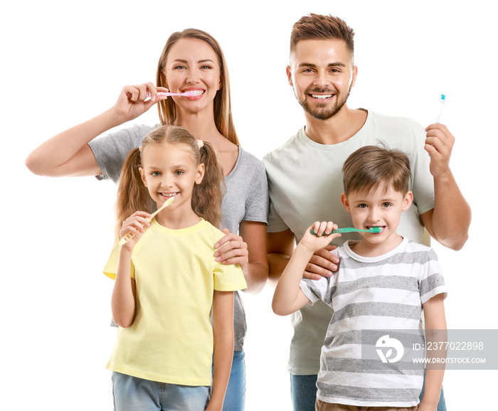 Portrait of family brushing teeth on white background