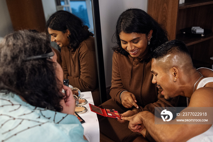 Group of friends doing each others make up at home during a sleepover