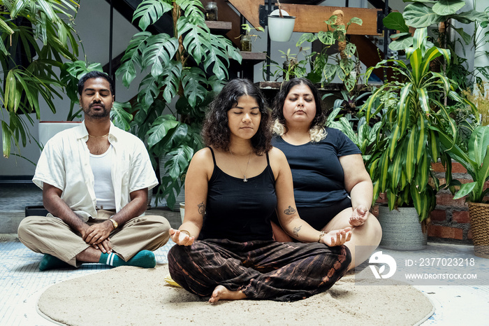 Friends meditating together at home