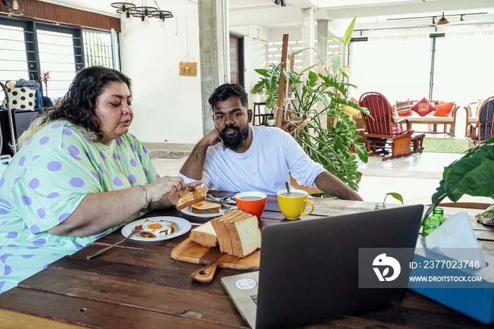 Couple making breakfast together at home in the morning