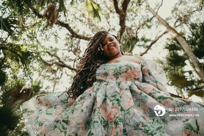 plus size Black woman looks down at camera