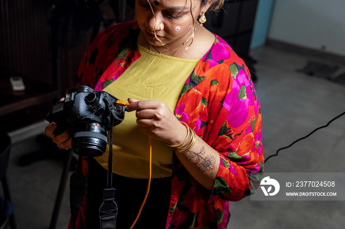 Plus sized female getting her headshots taken by a south asian female photographer