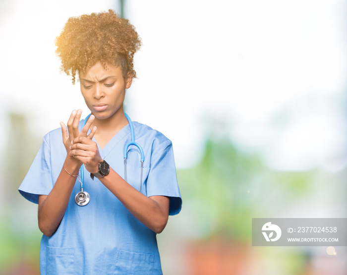 Young african american doctor woman over isolated background Suffering pain on hands and fingers, arthritis inflammation