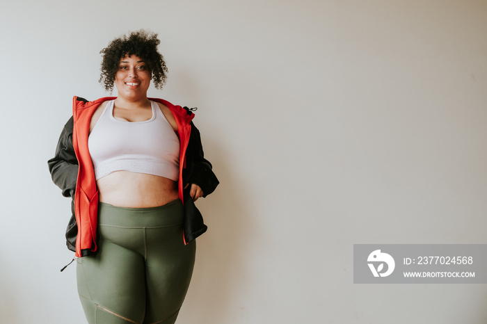 portrait of a plus size afro indigenous person wearing workout gear and smiling