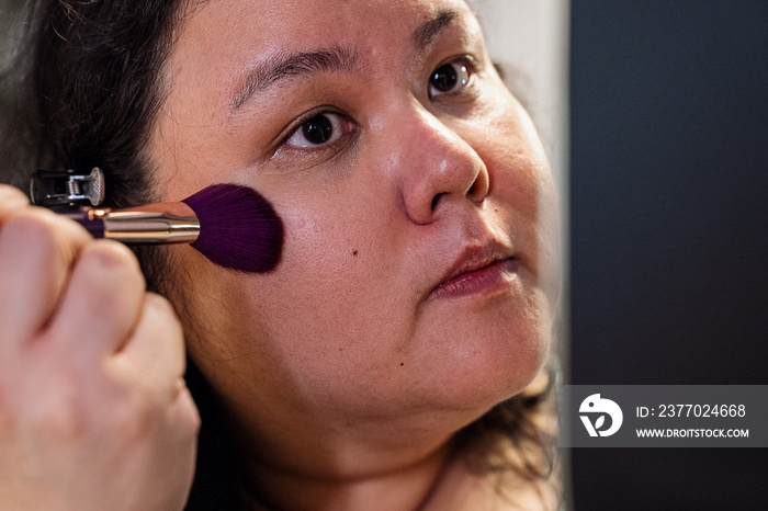 Group of friends doing each others make up at home during a sleepover