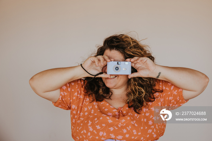 portrait of a plus size woman using camera