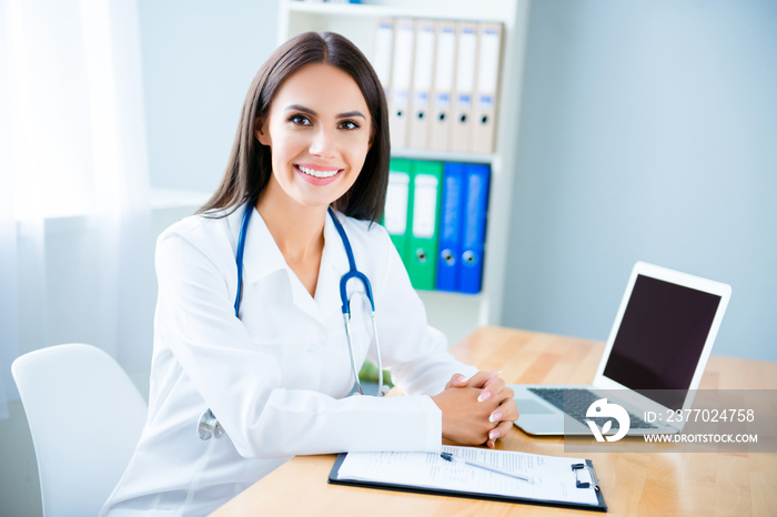 Portrait of cheerful happy female doctor on consultation