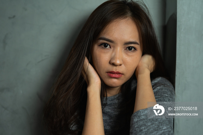 Close up face of young woman sitting sad, depression emotion, looking at camera in dark room, Portrait of young beautiful woman or female or girl sitting expression depression emotional alone