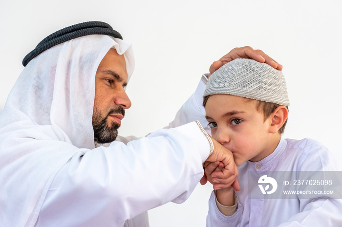 Arabic muslim son kissing his father hand