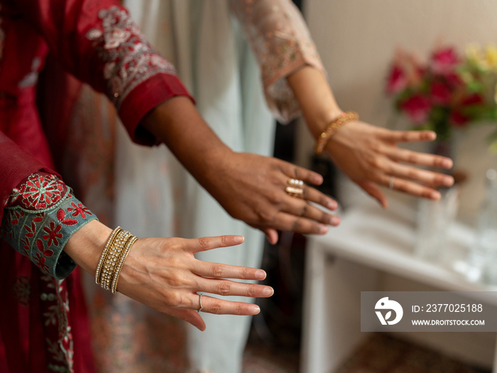 Women wearing jewelry on hands during Ramadan celebration