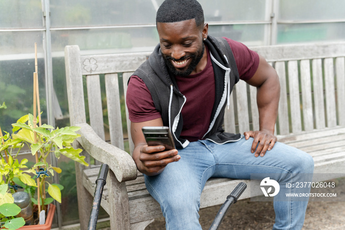 Smiling man photographing vegetables with smart phone