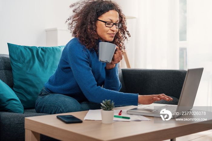 One black woman working from home using laptop