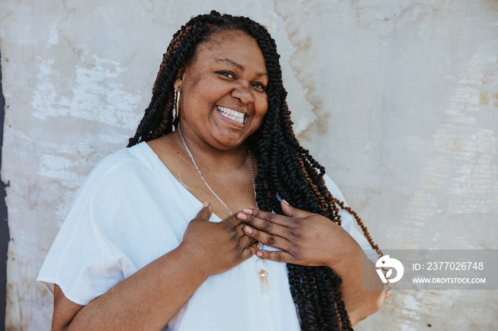 portrait of a plus size afro latinx haitian american woman with hands on heart