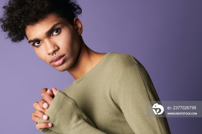 Handsome transgender brunette man in t-shirt looks to camera portrait shot