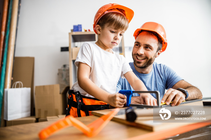 Little boy tindering with dad assistance stock photo