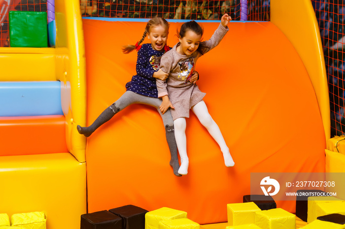 Two sisters bouncing in the trampoline park