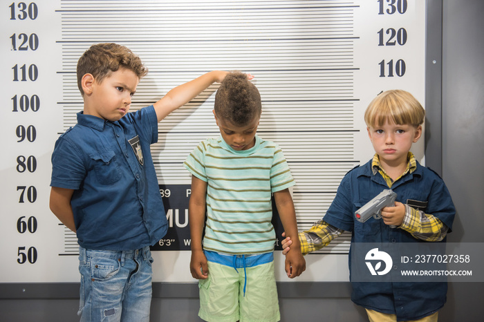 Kids playing police in amusement park. Children having fun in entertainment center.