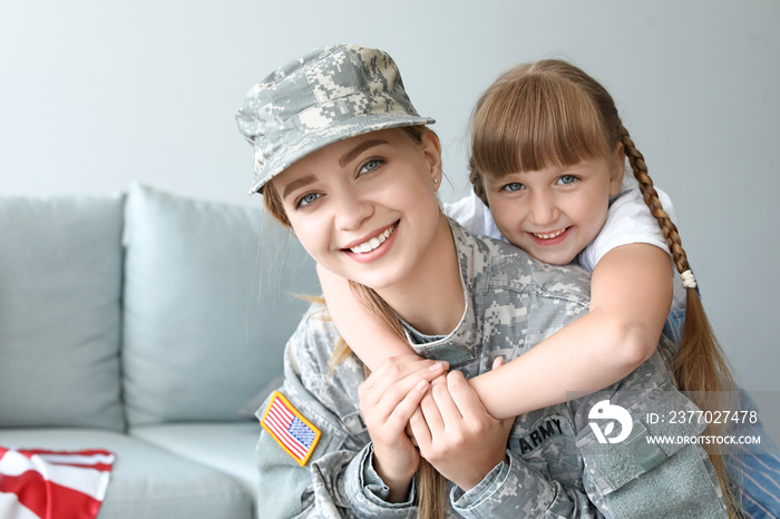 Happy female soldier with her daughter at home