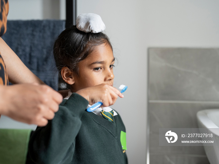 Mother and son (6-7) brushing teeth