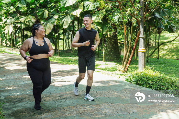 Two friends going on a run together in the park