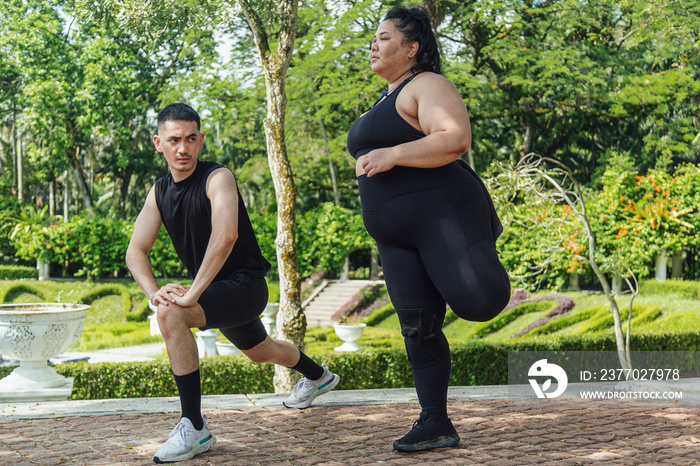 Two friends going on a run together in the park