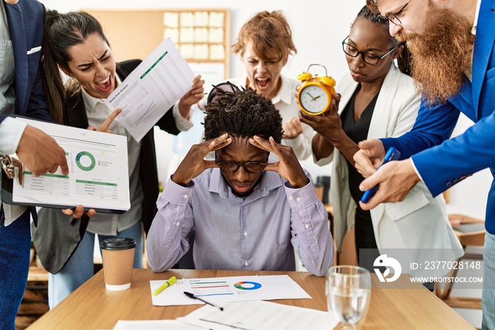 Group of business workers screaming to stressed partner at the office.