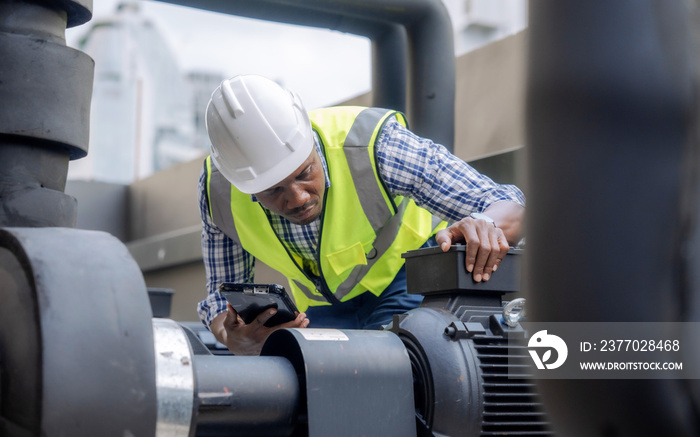 Engineer inspects a large industrial centrifugal pump.