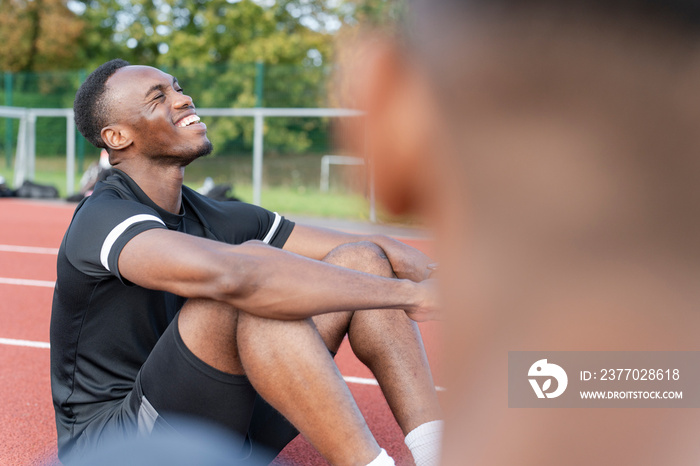 Athletes resting at sports track after training