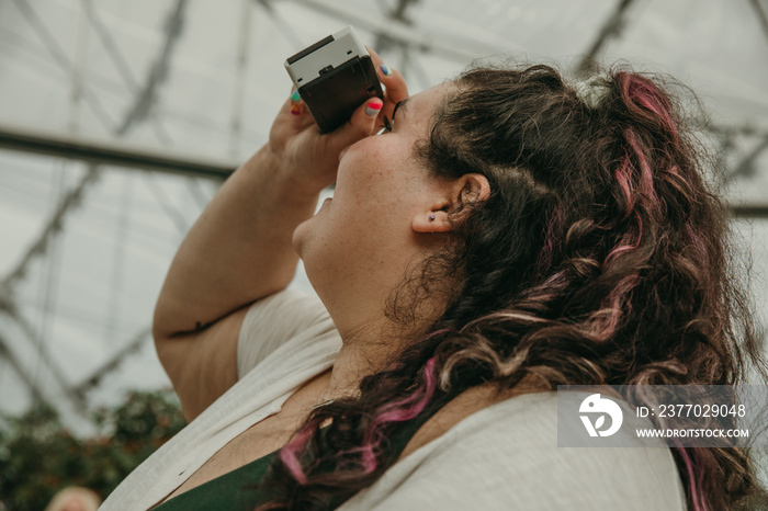 closeup of plus size woman using camera