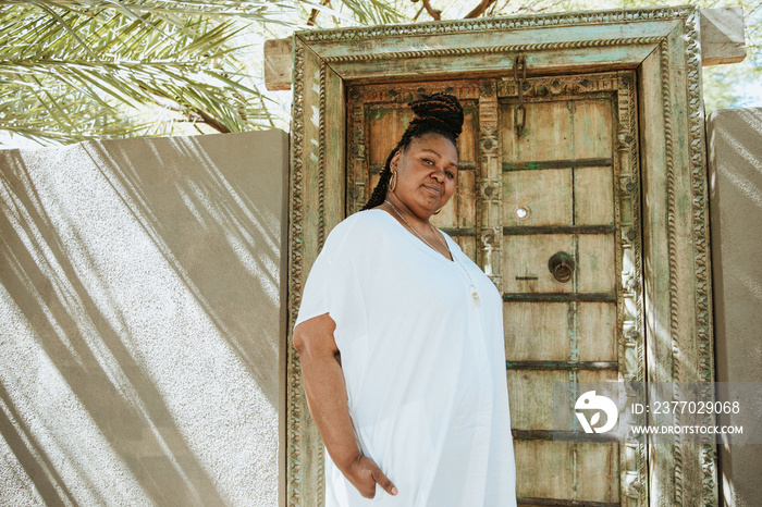 plus size African American woman standing outside a door