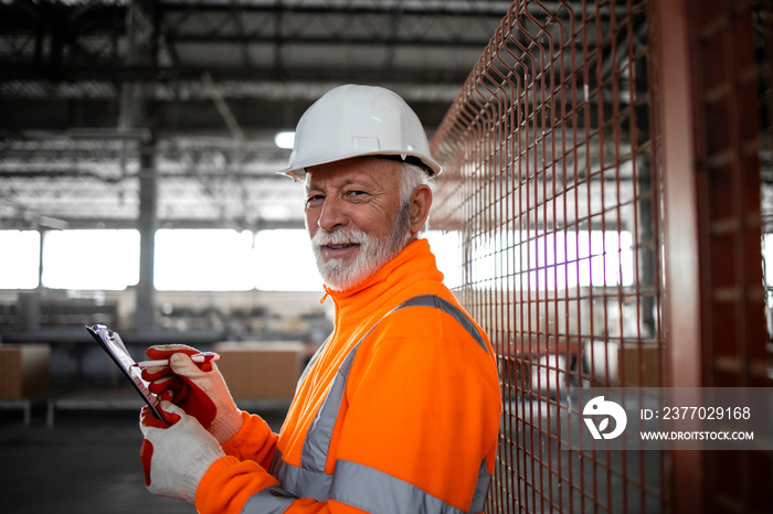 Portrait of gray haired senior factory worker.