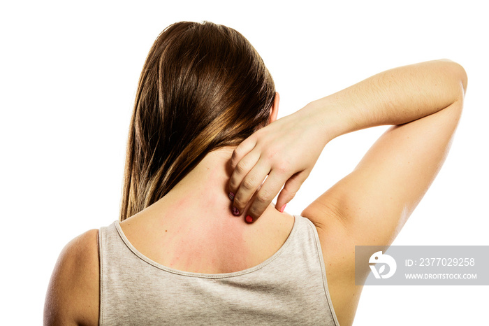 Woman scratching her back isolated