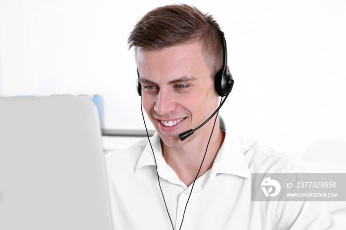 Young handsome technical support dispatcher working, closeup