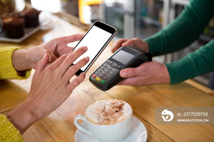 Barista accepting payment through smart phone