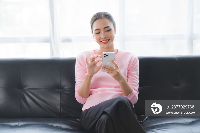 Closeup asian woman holding gold credit card and smartphone, sitting at home, happy satisfied young female customer shopping online, purchasing, making secure online payment.