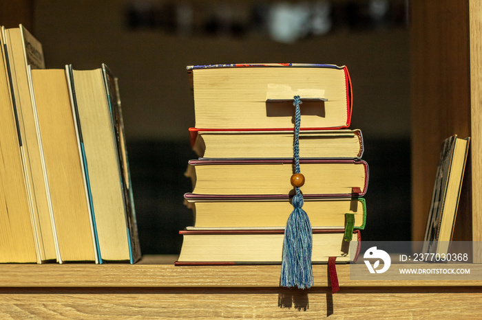 Books with bookmarks on the wooden shelf. Education, learn, study, knowledge and wisdom concept.