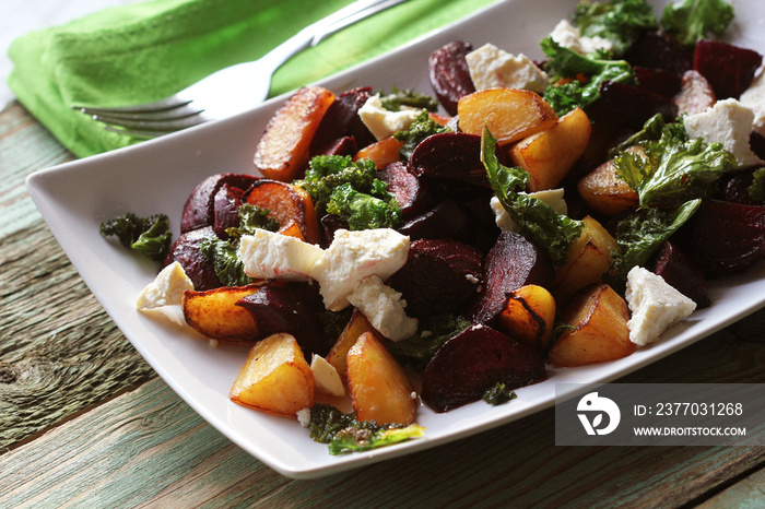 Fresh beet salad with feta cheese and fried cabbage kale