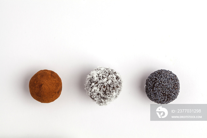 Homemade Healthy vegan Raw Energy Balls with carob, poppy and coconut isolated on white background, top view