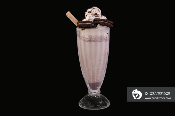 Delicious Milkshake garnish with whipped cream and biscuits in a glass,