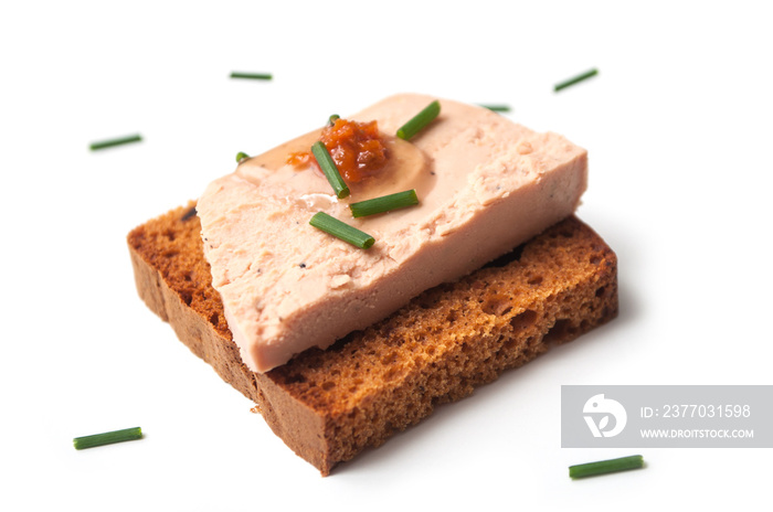 closeup of foie gras on gingerbread on white background