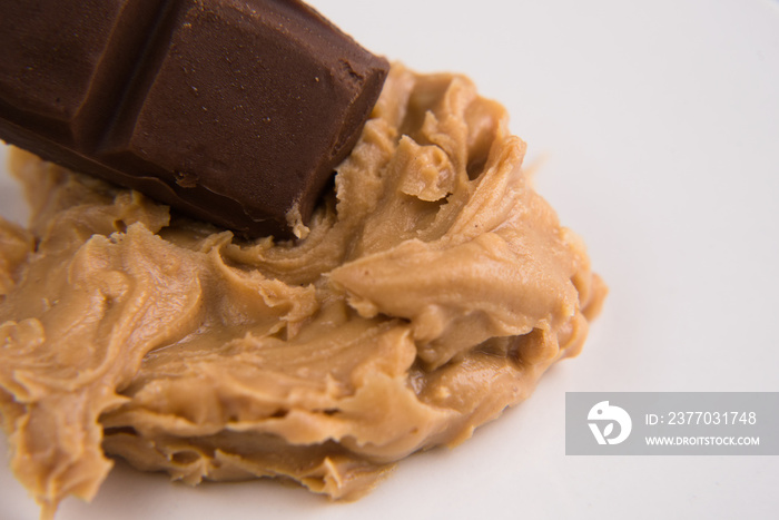 closeup of a peanut butter and chocolate bar over white background