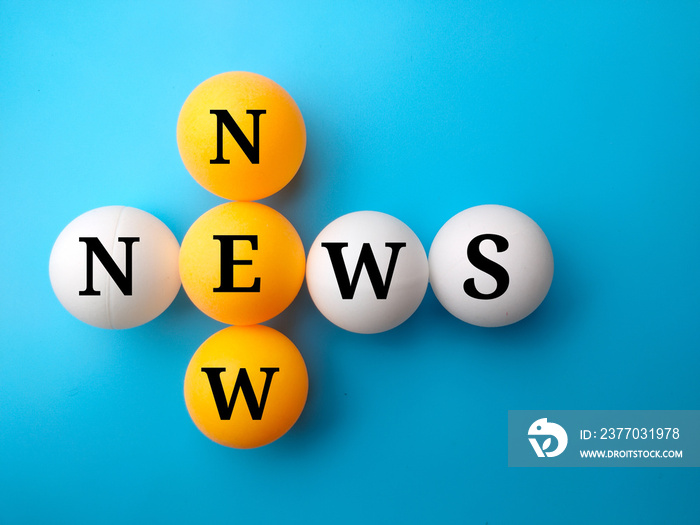 Pingpong ball written with text NEW NEWS on blue background.